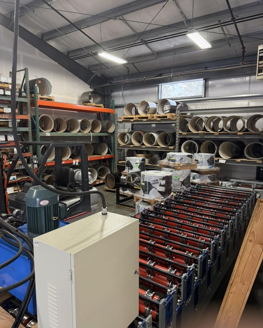 Caliber's in-shop roll-forming machine running panel material