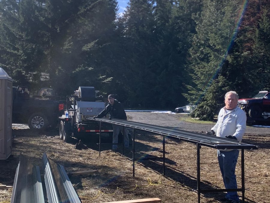Caliber team unloading panels at a forested jobsite